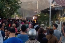 Petugas Damkar Polman memadamkan kebakaran rumah warga dengan disaksikan masyarakat di Jalan Mangundang, Polewali Mandar.