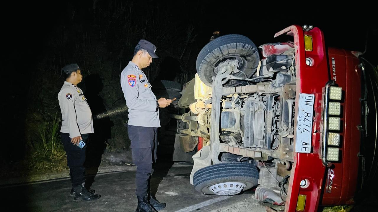 Truk pengangkut material bangunan terguling dan menutup badan jalan di Dusun Bontobundu, Desa Patallassang, Kecamatan Sinjai Timur.